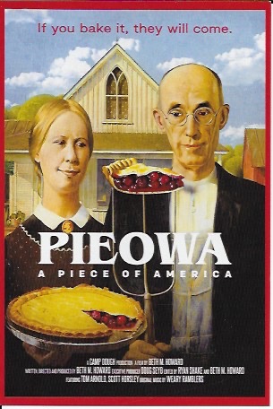 American Gothic couple in front of the American Gothic House staring at a piece of cherry pie stuck on the pitchfork, while the wife holds a pie with a slice cut out. Text reads: "if you bake it, they will come." "PIEOWA A PIECE OF AMERICA